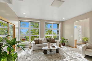 Living area featuring baseboard heating and recessed lighting