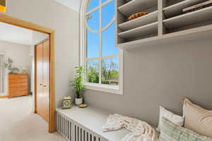 Living area featuring carpet flooring and radiator heating unit