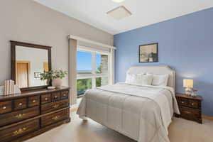 Bedroom with light colored carpet and baseboards