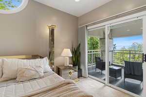 Bedroom with light colored carpet and access to exterior