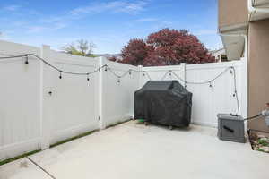 View of patio with grilling area and a gate