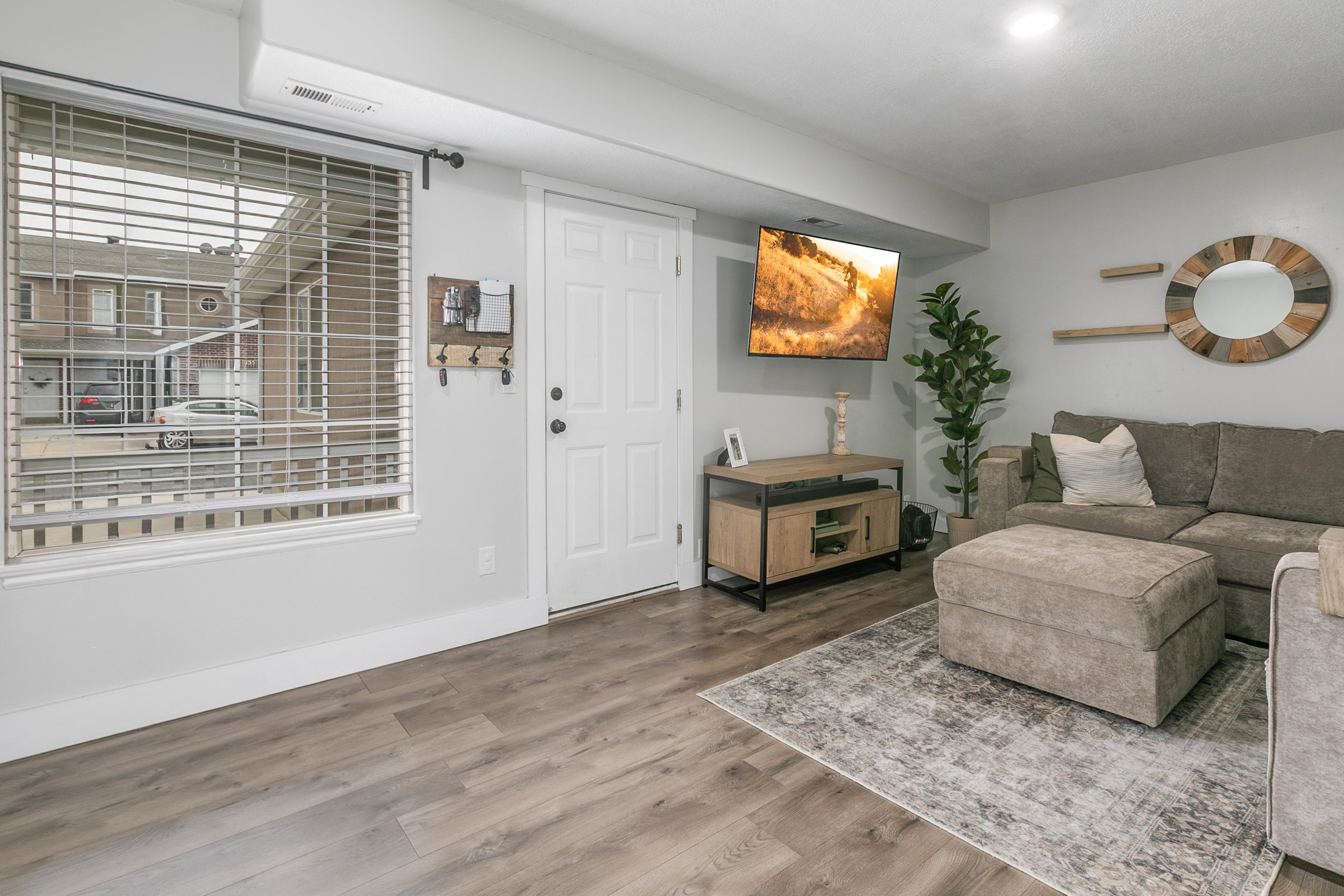 Living area with wood finished floors and baseboards