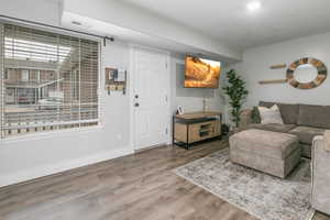 Living area with wood finished floors and baseboards