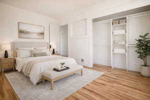 (virtual staging) Bedroom with light wood-style flooring and a closet