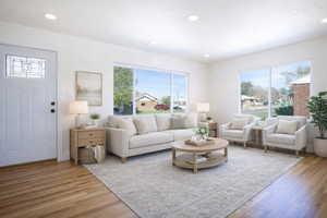 (virtual staging)Living area with light wood-style flooring and recessed lighting