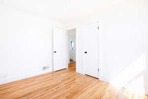 Spare room with light wood-style floors and ornamental molding