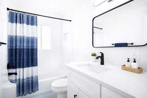 (virtual staging) Full bathroom with vanity, shower / tub combo with curtain, and ornamental molding