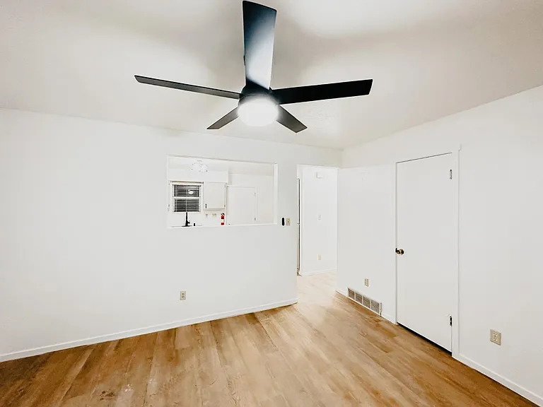 Spare room with light wood-style floors and a ceiling fan