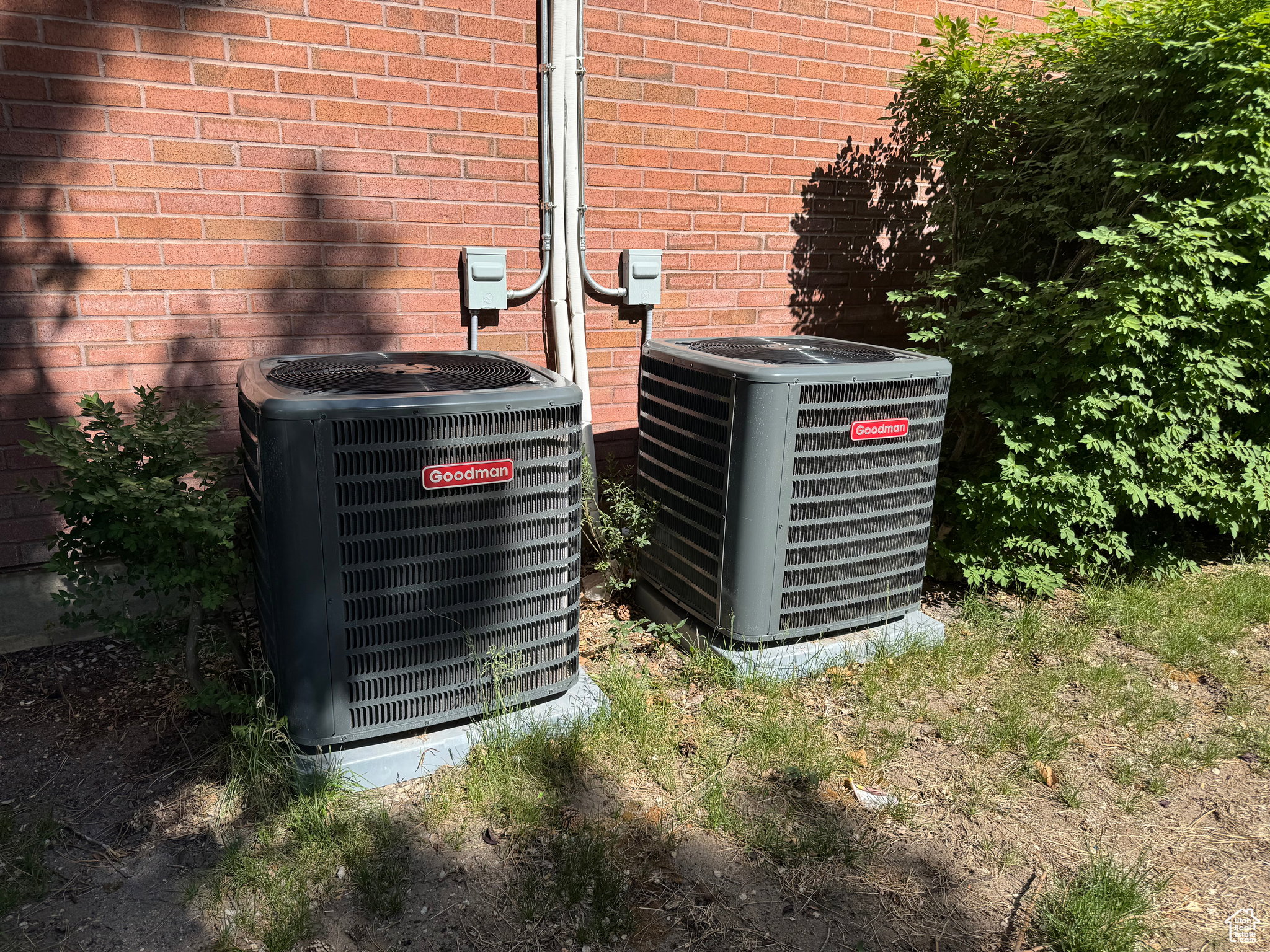 Exterior view of brick siding and a central air condition unit
