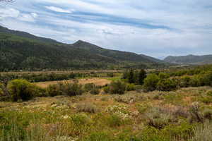 View of mountain backdrop featuring rural landscape