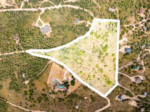 Aerial view of sparsely populated area featuring property parcel outlined