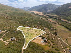 Overview of rural landscape with property boundaries highlighted and mountains
