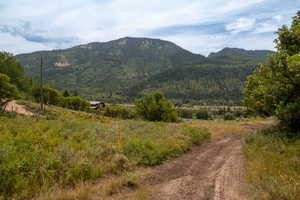 View of mountain background featuring rural landscape