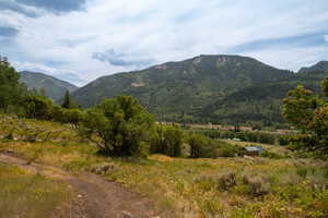 View of mountain backdrop with rural landscape
