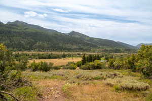 View of mountain backdrop with rural landscape