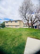 View of home's exterior with a lawn, a playground, and stucco siding