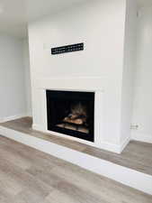 Detailed view of a fireplace and wood finished floors