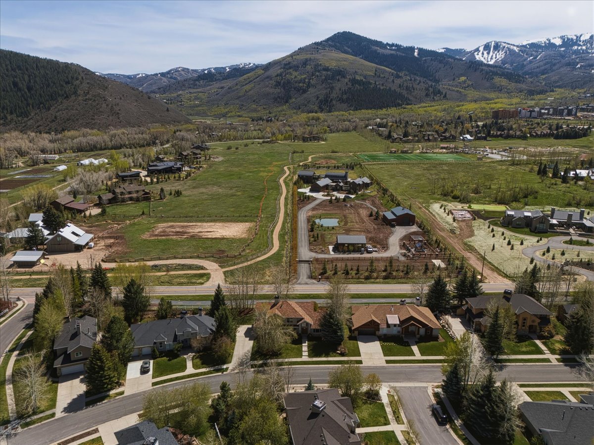 Aerial view of property's location featuring mountains and nearby suburban area