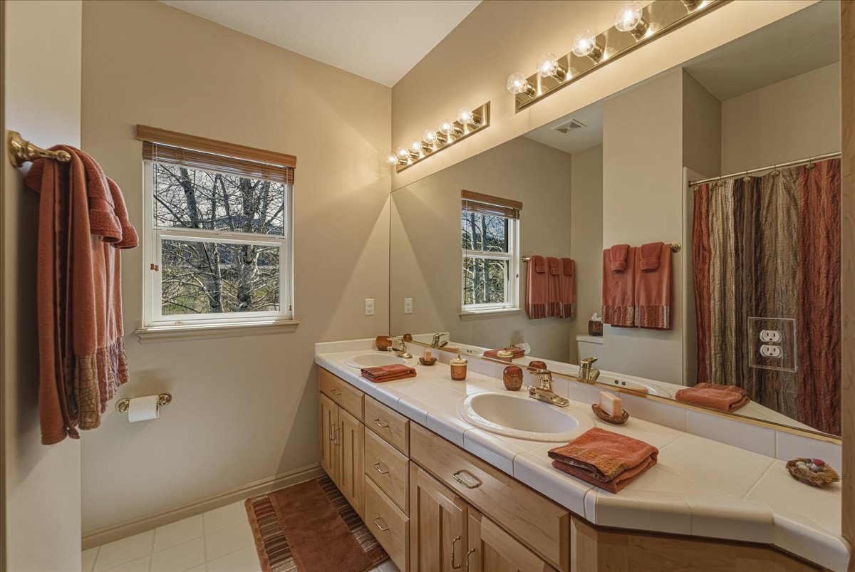 Bathroom with double vanity and curtained shower