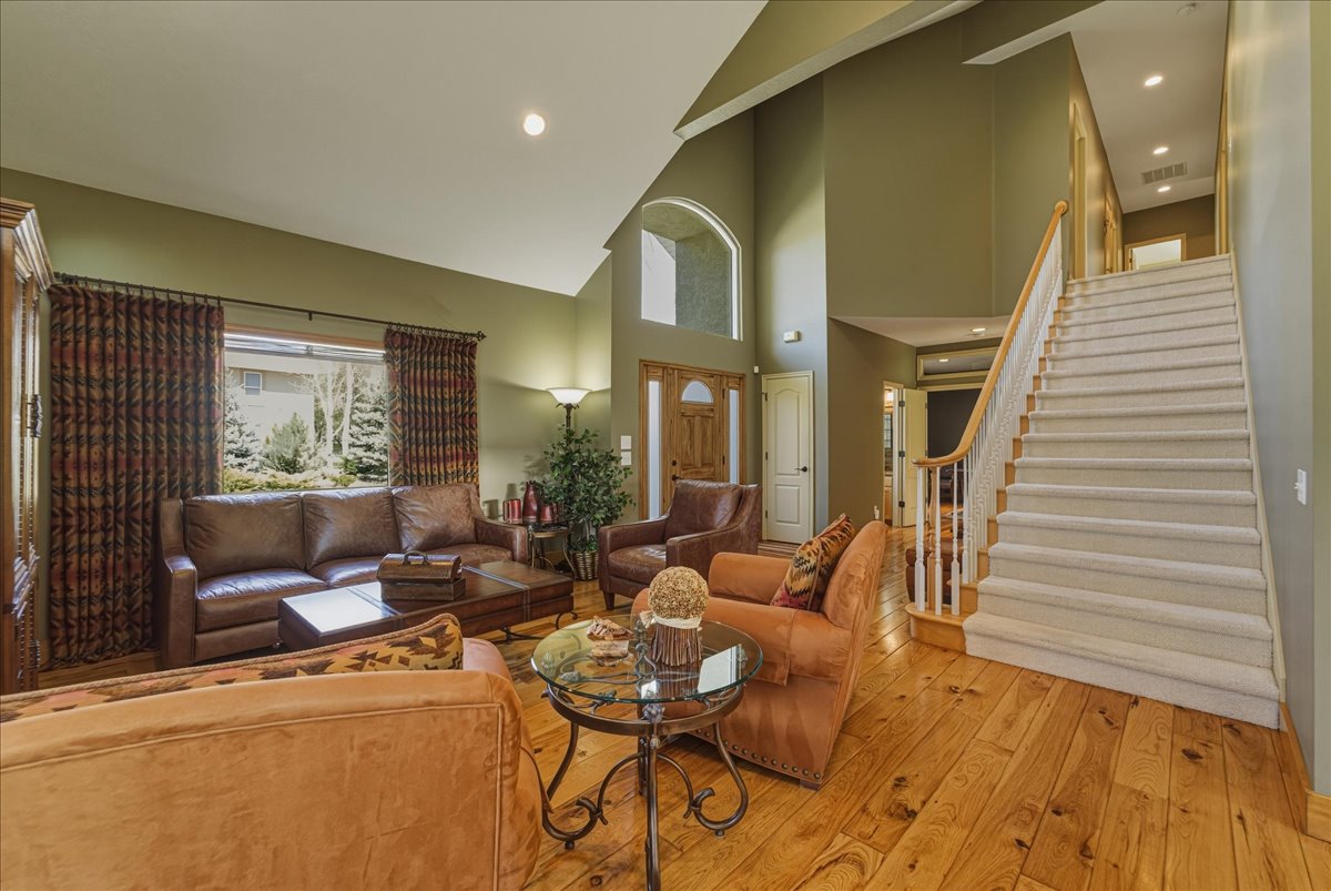 Living area with hardwood / wood-style flooring, recessed lighting, and lofted ceiling