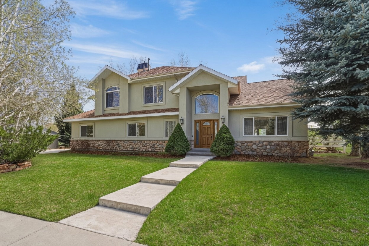 Mediterranean / spanish home with stucco siding, a front yard, stone siding, a chimney, and roof with shingles