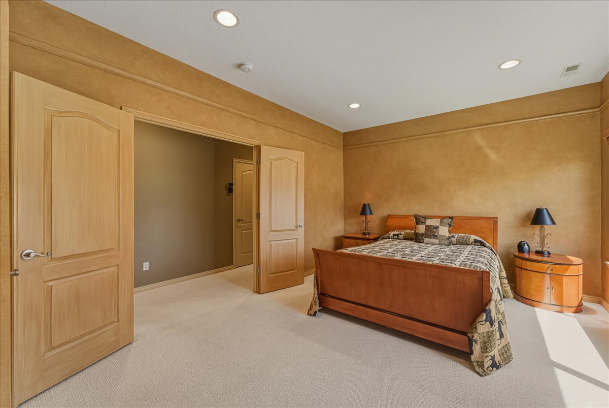 Bedroom featuring light colored carpet and recessed lighting