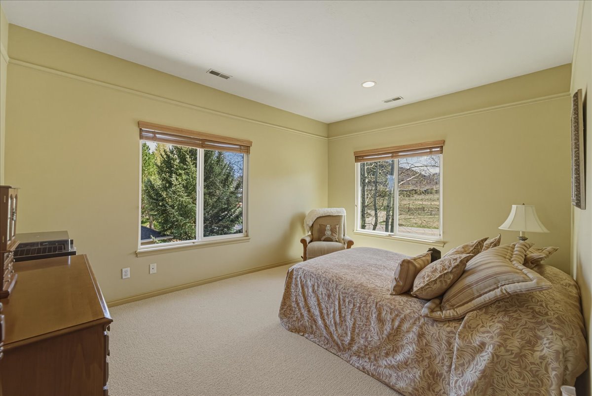 Bedroom with light colored carpet and recessed lighting