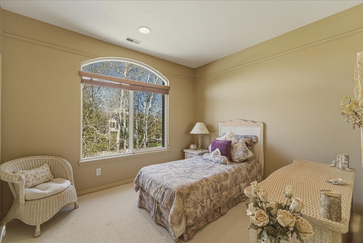 Carpeted bedroom featuring baseboards