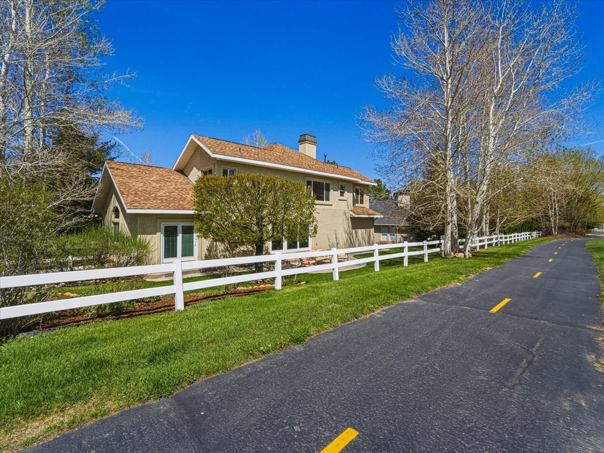 View of front of house featuring a fenced front yard, a chimney, and stucco siding