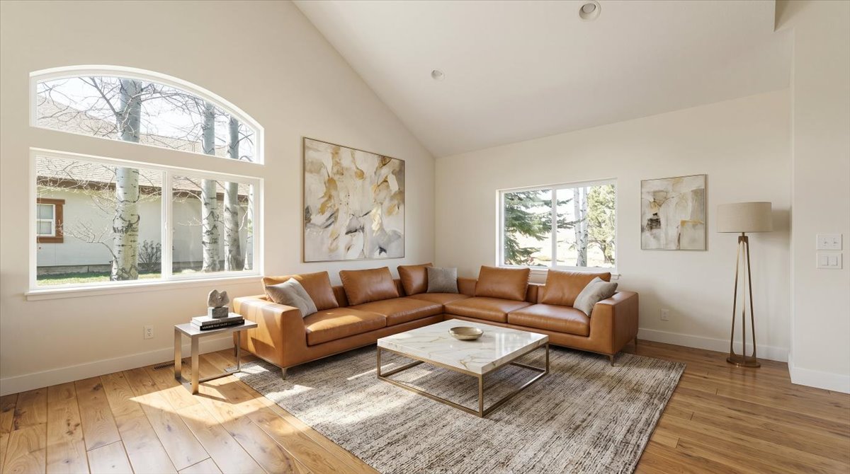 Living area featuring light wood-type flooring and vaulted ceiling