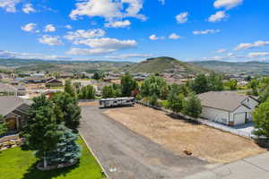 Aerial perspective of suburban area featuring a mountainous background