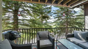 Balcony with a grill and an outdoor living space