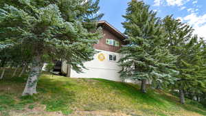View of green lawn featuring a deck