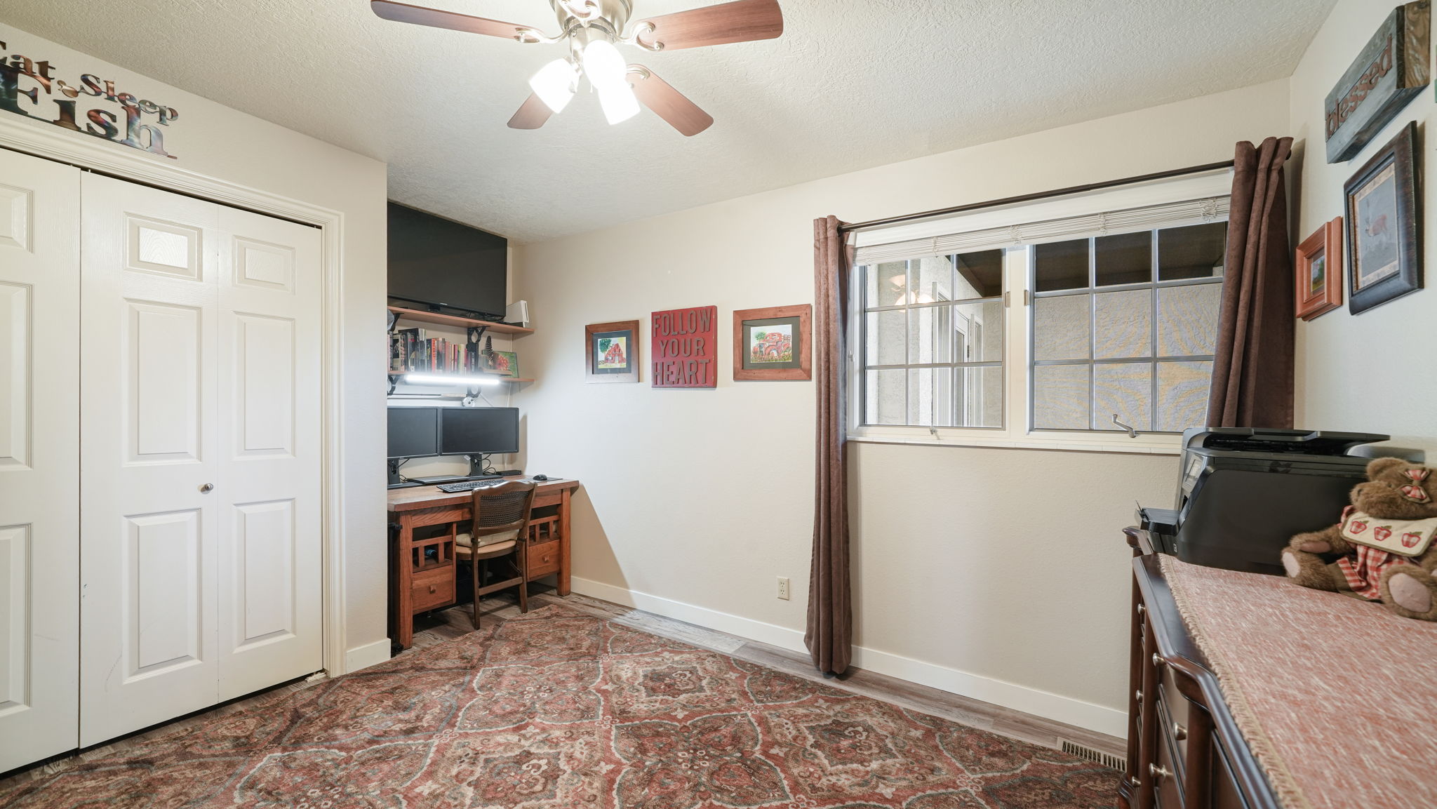 Office space with a textured ceiling and ceiling fan