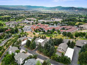 Aerial view of property and surrounding area with nearby suburban area