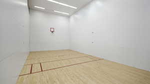 Surrounding community featuring a sport court and community basketball court