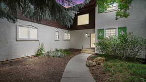 Entrance to property featuring stucco siding