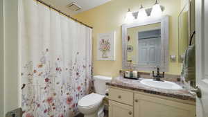 Bathroom featuring vanity and a shower with curtain