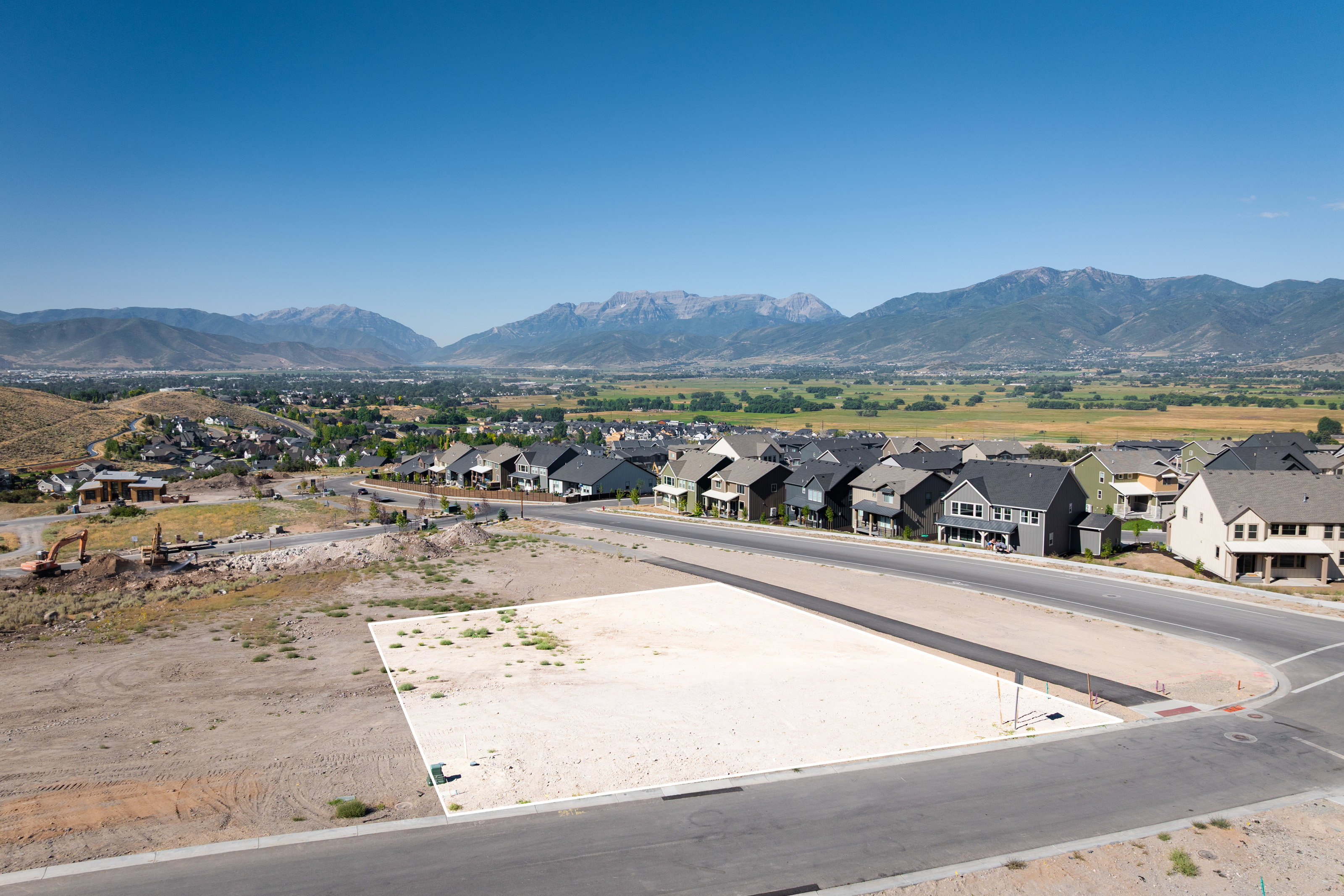 View of mountain backdrop featuring nearby suburban area