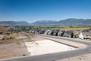 View of mountain backdrop featuring nearby suburban area