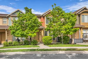View of property hidden behind natural elements featuring a fenced front yard