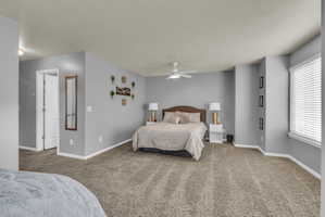 Carpeted bedroom with baseboards and ceiling fan