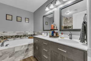 Bathroom with double vanity and a bath