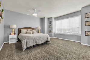 Bedroom with ceiling fan and carpet floors