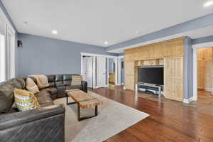 Living room featuring dark wood-style floors and recessed lighting