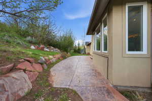 View of side of home featuring a patio area and stucco siding