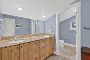 Full bathroom with double vanity and recessed lighting