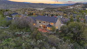 Bird's eye view of a mountain backdrop and a tree filled landscape