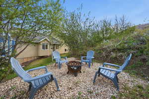 View of yard featuring an outdoor fire pit and a patio