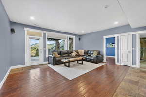 Living area with hardwood / wood-style flooring and recessed lighting